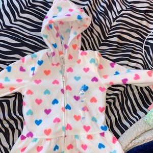 White ruffle bottom sweater with colorful hearts